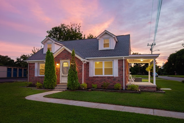 1200 Mill St, Pulaski, TN 38478 - cape cod house with brick siding, a yard, and a shingled roof