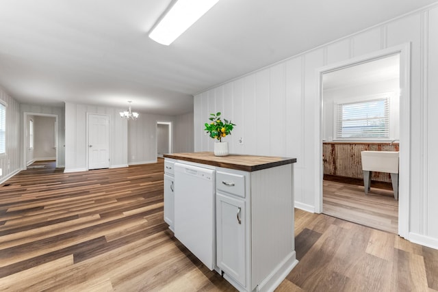 1200 Mill St, Pulaski, TN 38478 - kitchen featuring butcher block countertops, white dishwasher, a chandelier, a decorative wall, and wood finished floors