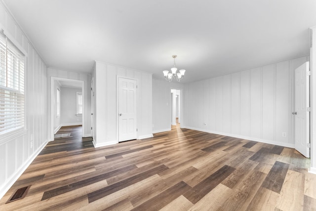 1200 Mill St, Pulaski, TN 38478 - unfurnished dining area featuring a decorative wall, a chandelier, and wood finished floors