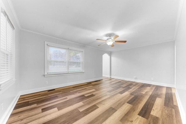 1200 Mill St, Pulaski, TN 38478 - empty room with ceiling fan, ornamental molding, arched walkways, and wood finished floors
