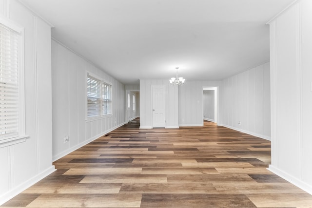 1200 Mill St, Pulaski, TN 38478 - unfurnished room featuring a decorative wall, a chandelier, and wood finished floors