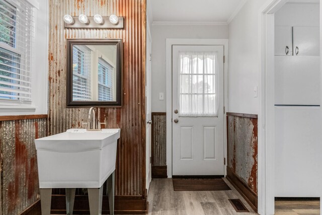 1200 Mill St, Pulaski, TN 38478 - doorway to outside featuring ornamental molding, wood finished floors, and wainscoting