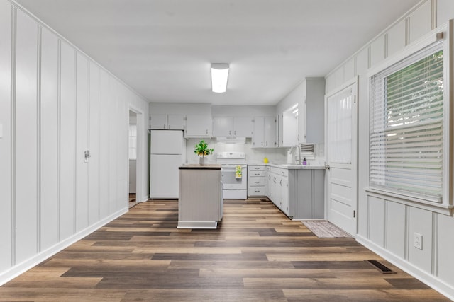 1200 Mill St, Pulaski, TN 38478 - kitchen featuring white appliances, a decorative wall, a center island, dark wood-style floors, and under cabinet range hood