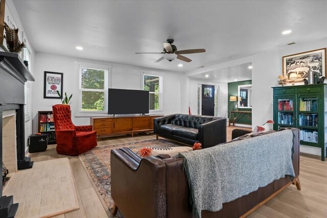 1030 Upper Creek Rd, Vanleer, TN 37181 - living area featuring light wood finished floors, ceiling fan, a brick fireplace, and recessed lighting
