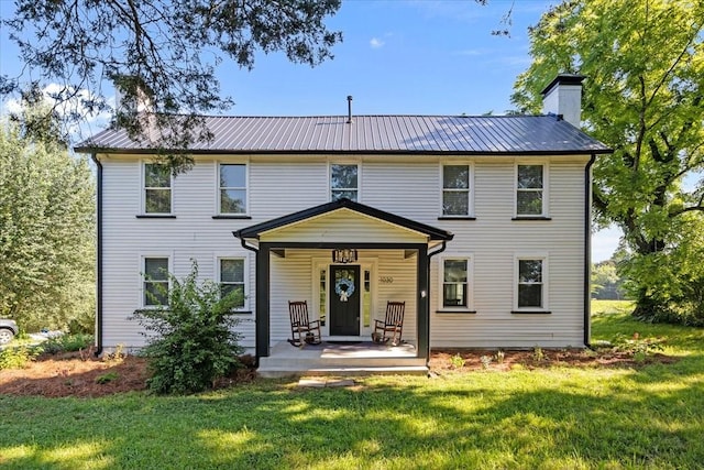 1030 Upper Creek Rd, Vanleer, TN 37181 - back of property with a lawn, a chimney, a porch, and a metal roof