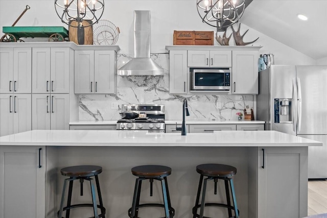 1030 Upper Creek Rd, Vanleer, TN 37181 - kitchen with appliances with stainless steel finishes, wall chimney range hood, a chandelier, vaulted ceiling, and decorative backsplash