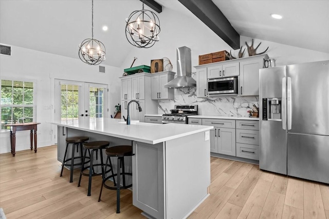 1030 Upper Creek Rd, Vanleer, TN 37181 - kitchen featuring appliances with stainless steel finishes, wall chimney exhaust hood, a chandelier, beam ceiling, and light countertops