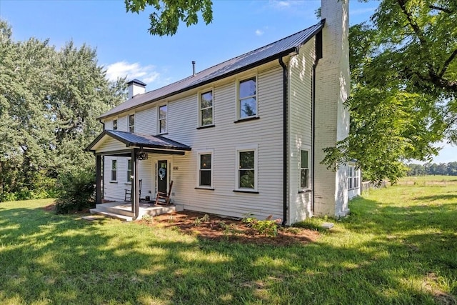 1030 Upper Creek Rd, Vanleer, TN 37181 - rear view of house featuring a chimney, a yard, and a metal roof