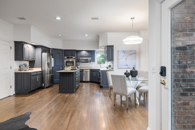 7075 Willowick Dr, Brentwood, TN 37027 - kitchen with stainless steel appliances, dark wood-type flooring, a center island, light countertops, and crown molding