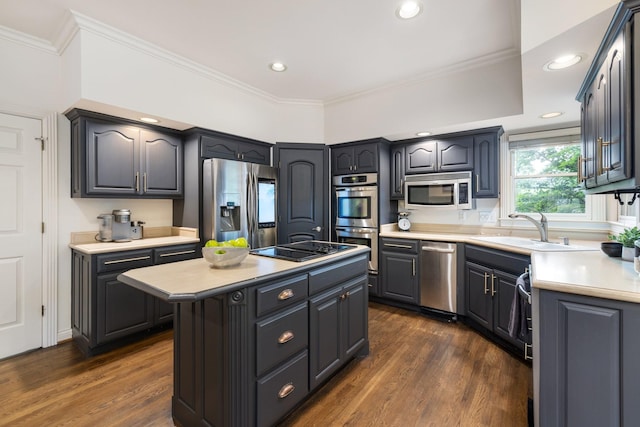 7075 Willowick Dr, Brentwood, TN 37027 - kitchen with appliances with stainless steel finishes, a center island, light countertops, dark wood-style flooring, and ornamental molding