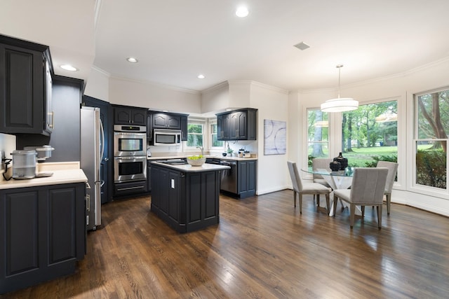 7075 Willowick Dr, Brentwood, TN 37027 - kitchen featuring stainless steel appliances, a kitchen island, light countertops, healthy amount of natural light, and ornamental molding