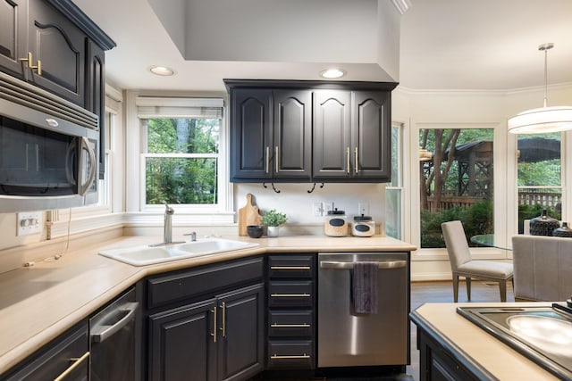 7075 Willowick Dr, Brentwood, TN 37027 - kitchen with appliances with stainless steel finishes, light countertops, decorative light fixtures, ornamental molding, and recessed lighting