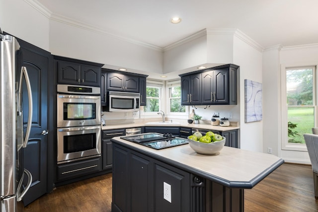 7075 Willowick Dr, Brentwood, TN 37027 - kitchen with appliances with stainless steel finishes, light countertops, dark wood-style floors, a kitchen island, and ornamental molding