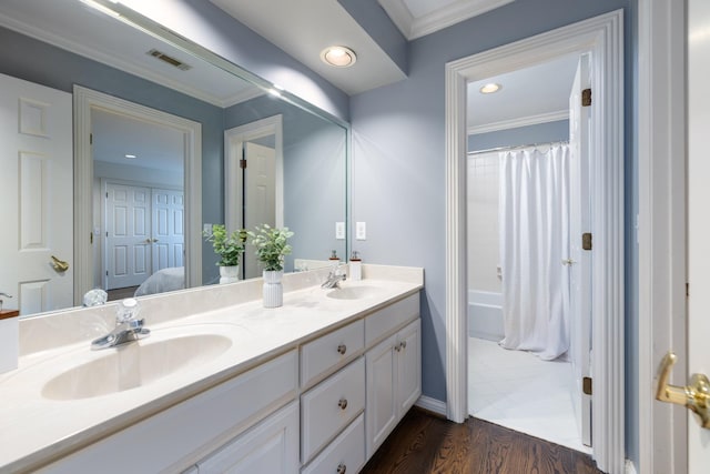 7075 Willowick Dr, Brentwood, TN 37027 - bathroom featuring double vanity, wood finished floors, ornamental molding, recessed lighting, and shower / bath combination with curtain