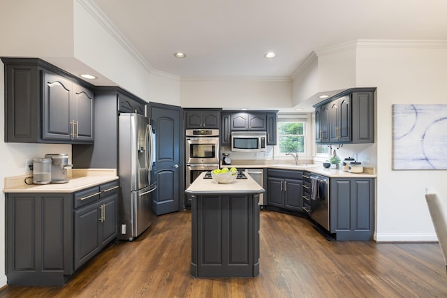 7075 Willowick Dr, Brentwood, TN 37027 - kitchen with appliances with stainless steel finishes, dark wood finished floors, a kitchen island, light countertops, and crown molding