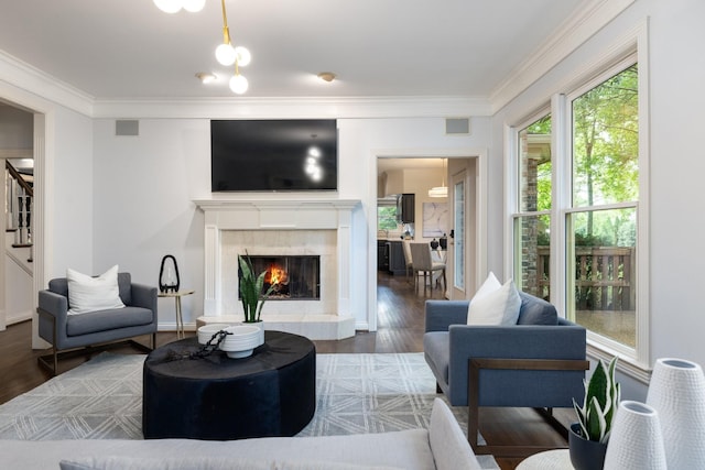 7075 Willowick Dr, Brentwood, TN 37027 - living area featuring wood finished floors, crown molding, stairs, and a fireplace