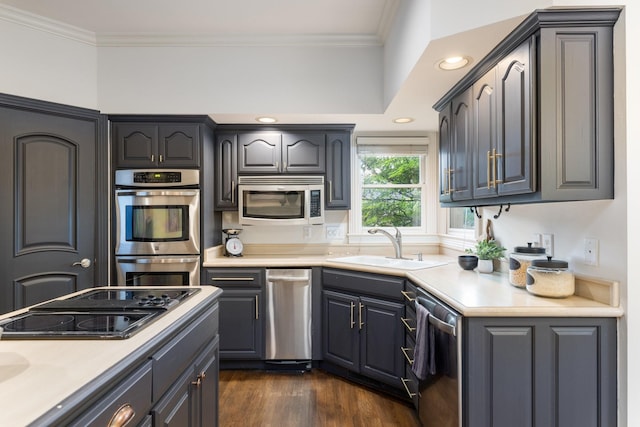 7075 Willowick Dr, Brentwood, TN 37027 - kitchen featuring stainless steel appliances, crown molding, dark wood-style floors, light countertops, and recessed lighting