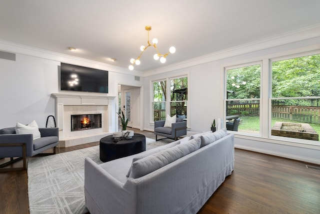 7075 Willowick Dr, Brentwood, TN 37027 - living area featuring a chandelier, crown molding, wood finished floors, and a tile fireplace