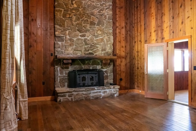 7030 Dodson Branch Rd, Cookeville, TN 38501 - unfurnished living room with hardwood / wood-style floors, wooden walls, and a stone fireplace
