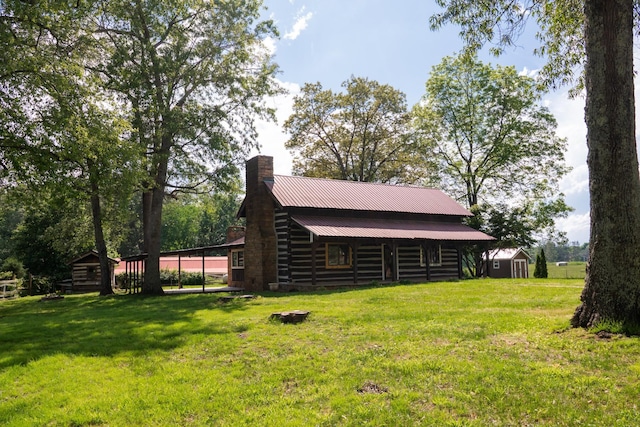 7030 Dodson Branch Rd, Cookeville, TN 38501 - view of side of home with a chimney, a storage shed, and a lawn