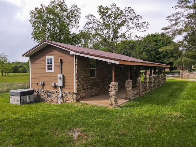 7030 Dodson Branch Rd, Cookeville, TN 38501 - view of home's exterior featuring stone siding, a patio area, and a metal roof