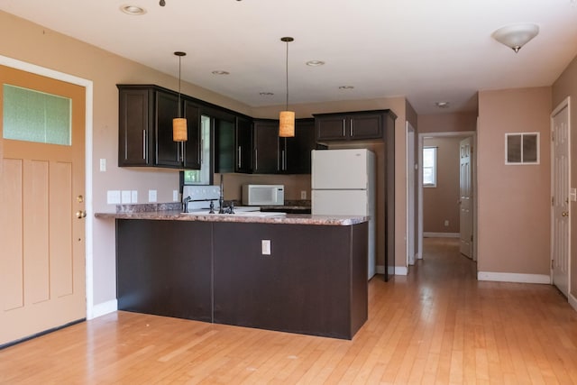 7030 Dodson Branch Rd, Cookeville, TN 38501 - kitchen featuring white appliances, light wood-style floors, a peninsula, hanging light fixtures, and recessed lighting