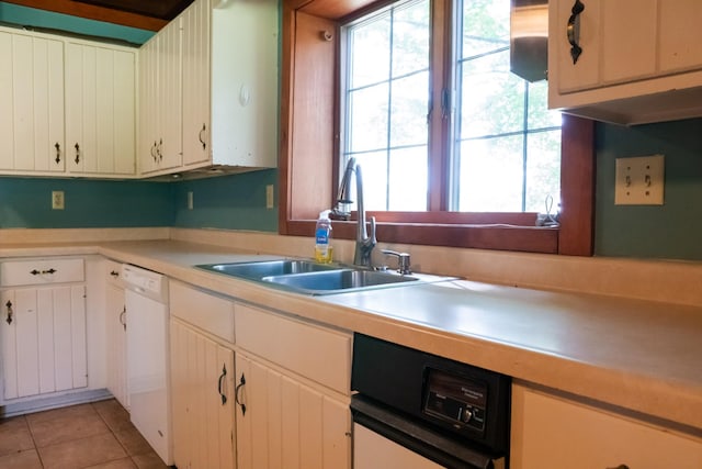 7030 Dodson Branch Rd, Cookeville, TN 38501 - kitchen with white dishwasher, light countertops, light tile patterned floors, and white cabinetry