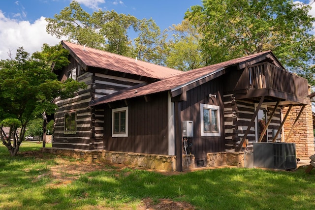 7030 Dodson Branch Rd, Cookeville, TN 38501 - view of property exterior with log exterior, a yard, a metal roof, and water heater