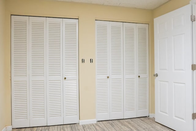 745 Contraband Ln, Cookeville, TN 38501 - unfurnished bedroom with multiple closets and light wood-type flooring