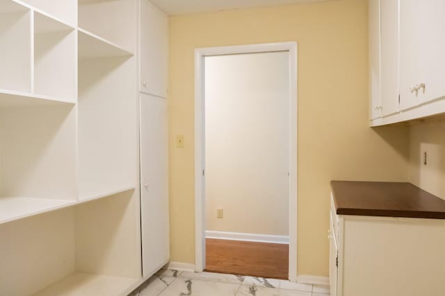 745 Contraband Ln, Cookeville, TN 38501 - kitchen featuring light marble finish flooring, dark countertops, and white cabinets