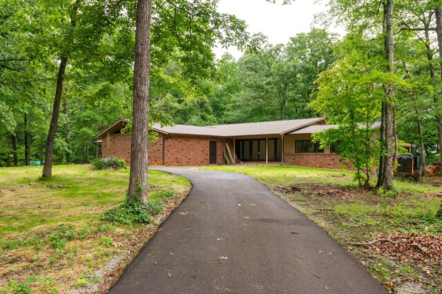 745 Contraband Ln, Cookeville, TN 38501 - view of front of home featuring brick siding, asphalt driveway, and a front lawn