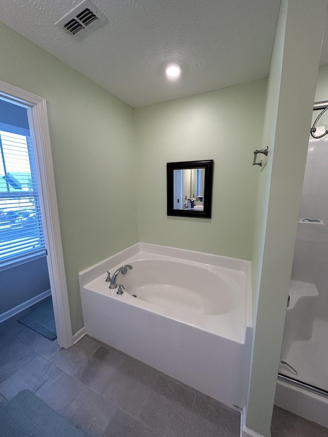 4437 Sunday Silence Way, Murfreesboro, TN 37128 - bathroom featuring a bath, a textured ceiling, and a stall shower