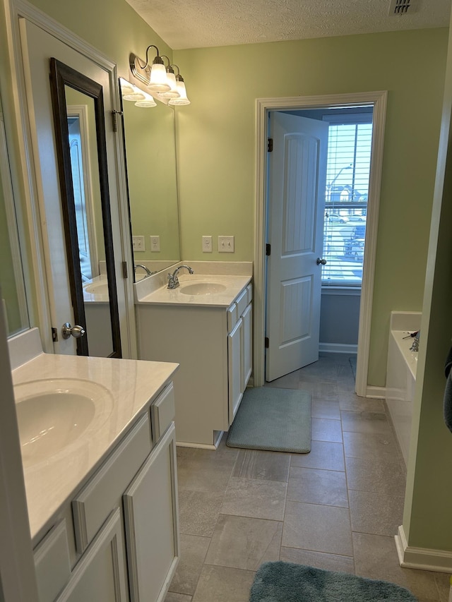 4437 Sunday Silence Way, Murfreesboro, TN 37128 - full bathroom with two vanities, a bath, and a textured ceiling