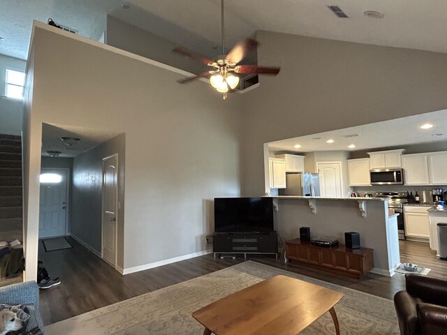 4437 Sunday Silence Way, Murfreesboro, TN 37128 - living area featuring dark wood-style flooring, high vaulted ceiling, a ceiling fan, stairs, and recessed lighting