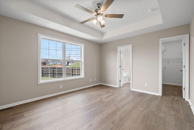 3798 Bret Dr, Clarksville, TN 37040 - unfurnished bedroom featuring a raised ceiling, a spacious closet, wood finished floors, a closet, and ensuite bath