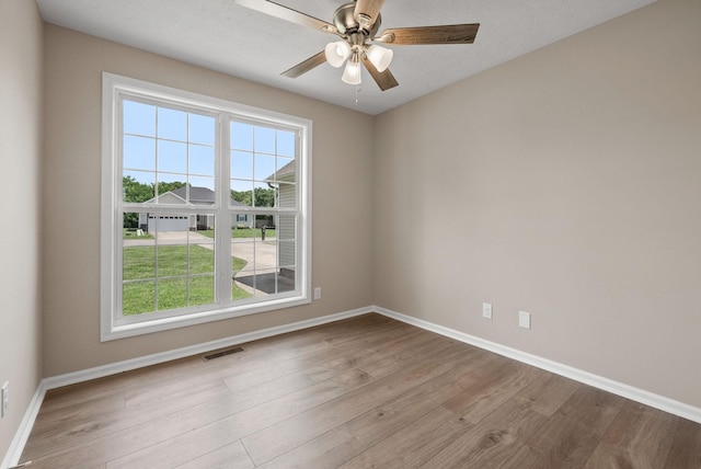 3798 Bret Dr, Clarksville, TN 37040 - empty room with plenty of natural light, wood finished floors, and a ceiling fan