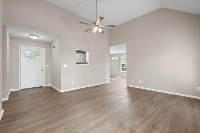 3798 Bret Dr, Clarksville, TN 37040 - unfurnished living room featuring healthy amount of natural light, ceiling fan, wood finished floors, a chandelier, and high vaulted ceiling