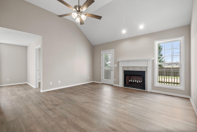 3798 Bret Dr, Clarksville, TN 37040 - unfurnished living room with plenty of natural light, ceiling fan, lofted ceiling, a tile fireplace, and wood finished floors