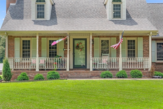 915 Rocky Hollow Rd, Erin, TN 37061 - view of front of home featuring covered porch, a front lawn, roof with shingles, brick siding, and a chimney