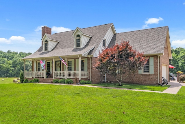 915 Rocky Hollow Rd, Erin, TN 37061 - new england style home featuring a porch, a chimney, brick siding, a front yard, and a garage