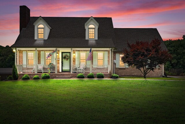 915 Rocky Hollow Rd, Erin, TN 37061 - view of front of home featuring covered porch, a chimney, a yard, and brick siding