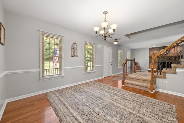 915 Rocky Hollow Rd, Erin, TN 37061 - foyer featuring a chandelier, wood finished floors, stairway, and healthy amount of natural light