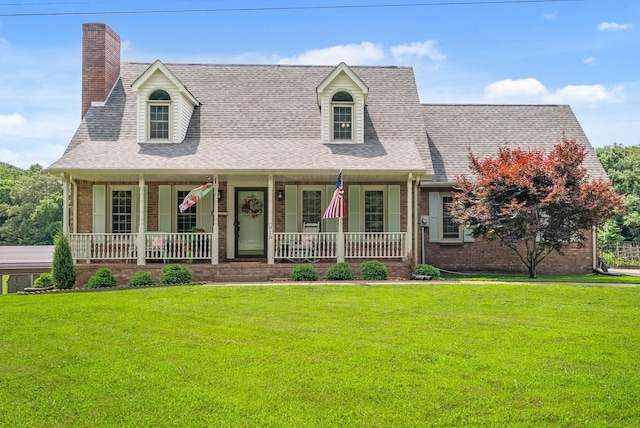 915 Rocky Hollow Rd, Erin, TN 37061 - new england style home with covered porch, brick siding, a front yard, and a shingled roof