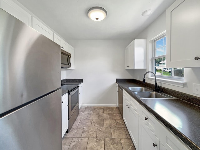 147 Greystone Dr, Springfield, TN 37172 - kitchen with stainless steel appliances, dark countertops, white cabinetry, and light stone finish floors