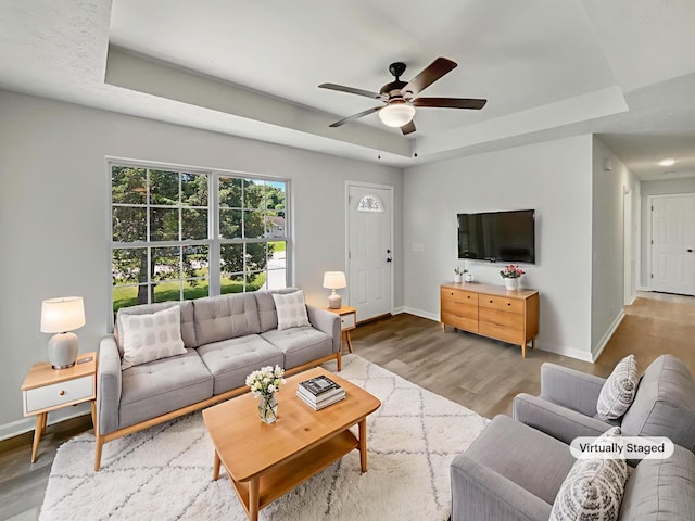 147 Greystone Dr, Springfield, TN 37172 - living area featuring a tray ceiling, a ceiling fan, and wood finished floors