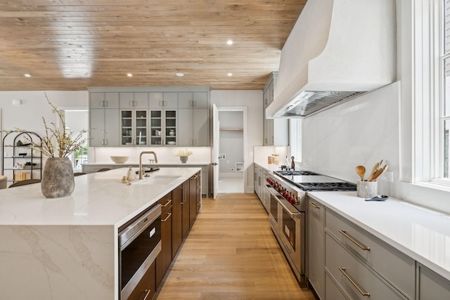 6315 Callie Ln, Brentwood, TN 37027 - kitchen with double oven range, wood ceiling, a large island with sink, light wood-style flooring, and dishwasher