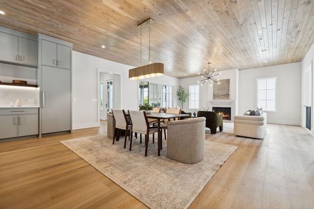 6315 Callie Ln, Brentwood, TN 37027 - dining area featuring a lit fireplace, light wood-style flooring, wood ceiling, recessed lighting, and a chandelier