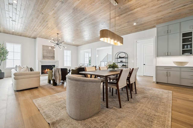 6315 Callie Ln, Brentwood, TN 37027 - dining area featuring plenty of natural light, wooden ceiling, light wood-style flooring, and a warm lit fireplace