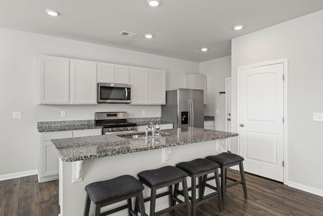 830 Long Leaf Rd, Lebanon, TN 37087 - kitchen featuring stainless steel appliances, dark wood-style floors, a breakfast bar area, stone countertops, and recessed lighting