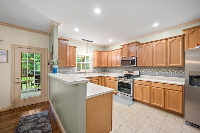 116 Sherrolyn Ct, Burns, TN 37029 - kitchen featuring appliances with stainless steel finishes, ornamental molding, a peninsula, tasteful backsplash, and light countertops